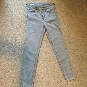 Gray skinny jeans with distressed bottom